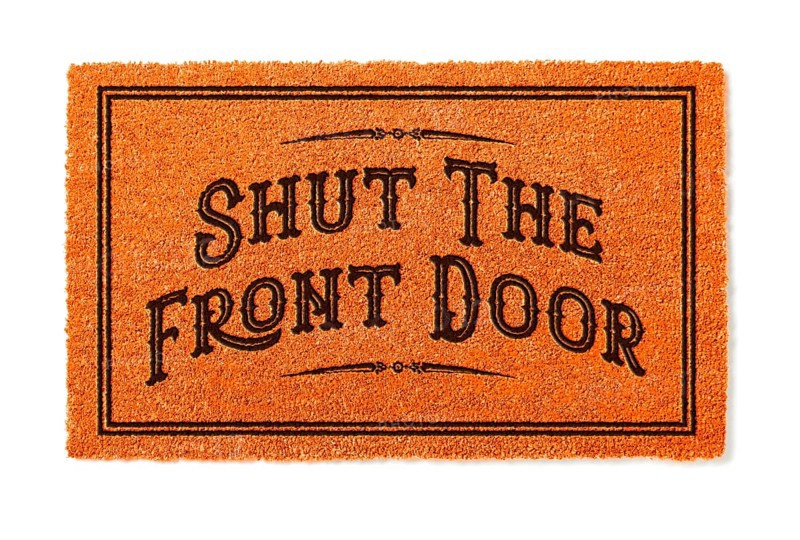 Shut the front door halloween orange welcome mat isolated on white background