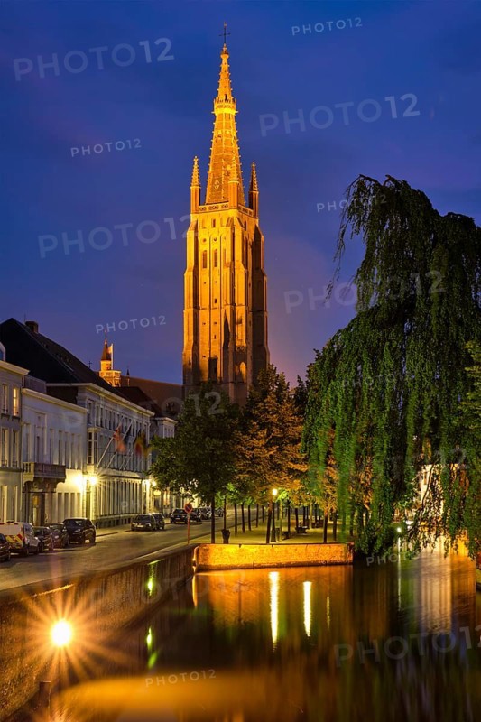 Church of Our Lady and canal illuminated in the night. Brugge Bruges