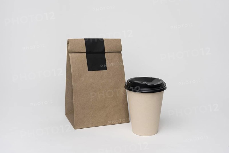 Arrangement with paper bag coffee cup