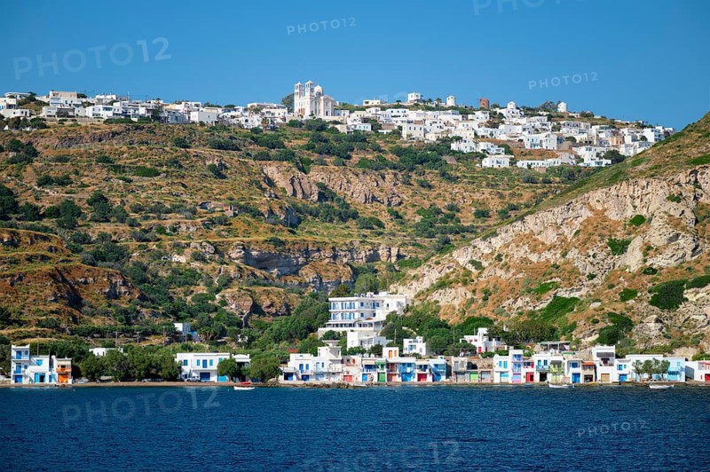 Klima and Plaka villages with whitewhashed traditional houses and orthodox church and windmills on Milos island