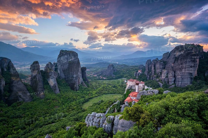 Sunset sky and monastery of Rousanou and Monastery of St. Nicholas Anapavsa in famous greek tourist destination Meteora in Greece with dramatic sky