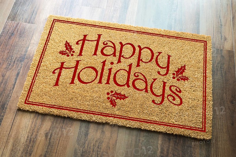 Happy holidays christmas tad welcome mat on wood floor background