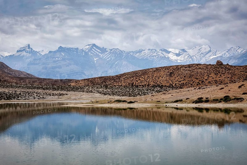Himalayas mountains refelcting in mountain lake Dhankar Lake