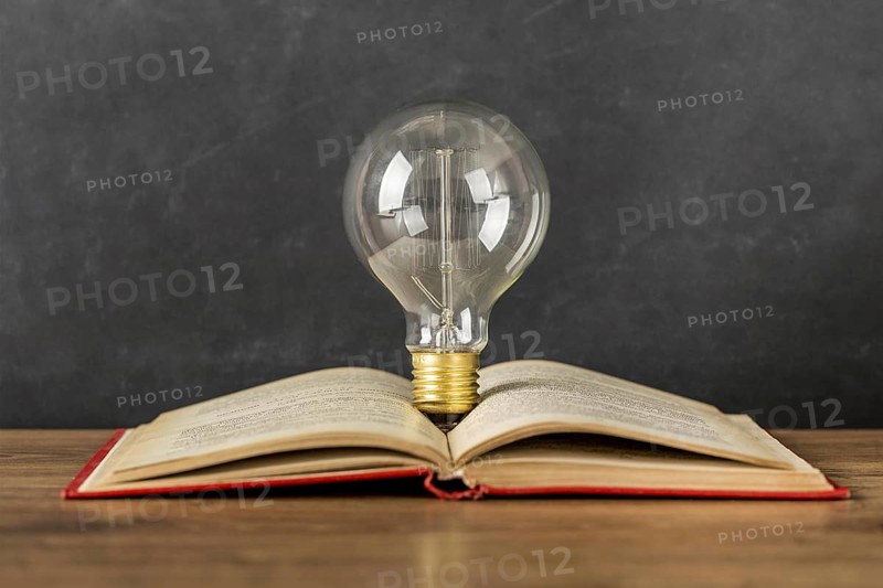 Arrangement with book and light bulb
