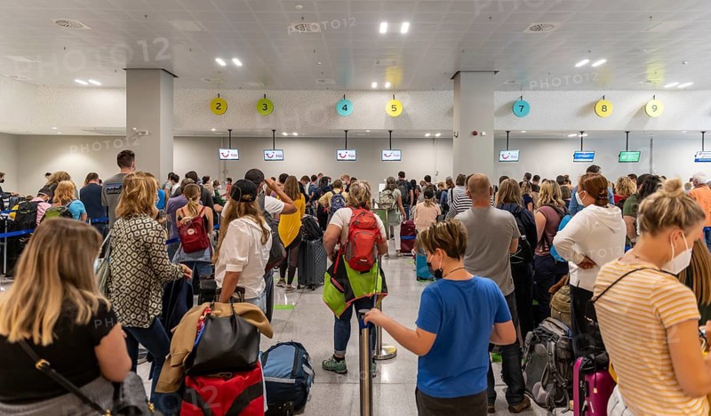 Tourists waiting at the counter in the airport