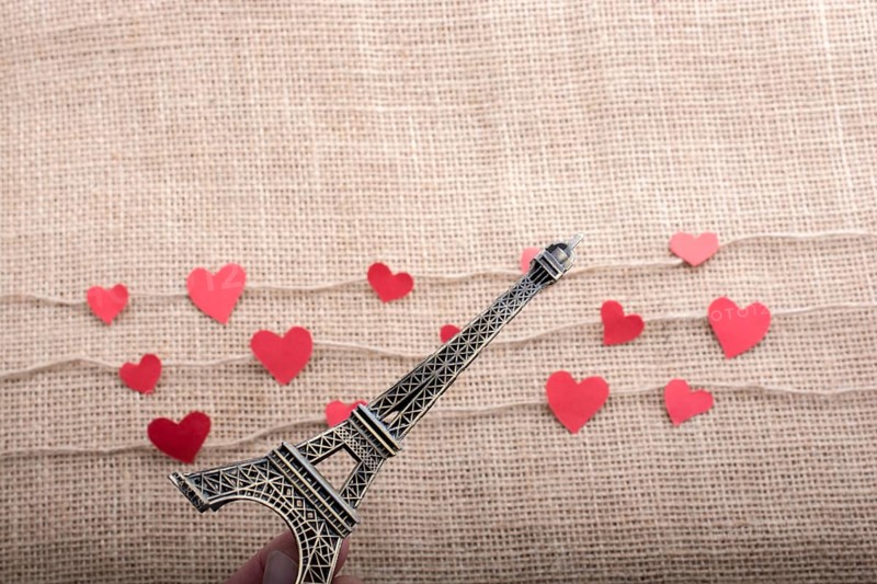 Love concept with Eiffel tower and paper heart on threads