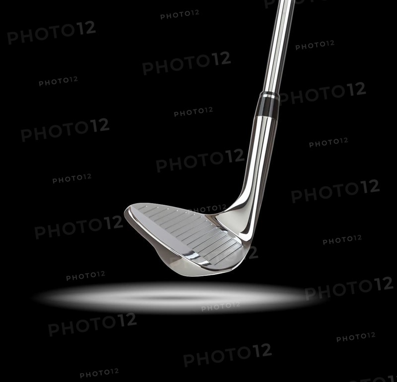 Chrome golf club wedge iron under spot light with black background