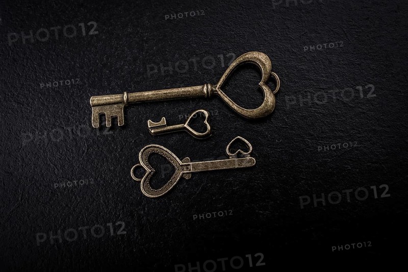 Heart shaped retro metal keys on dark background