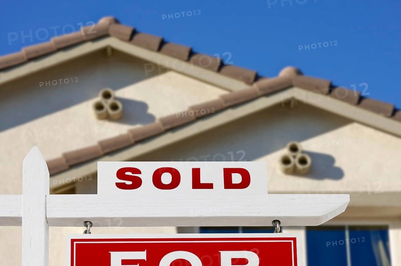Sold home for sale real estate sign and house