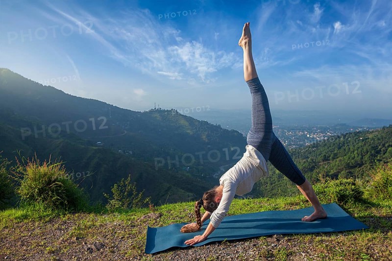 Young sporty fit woman doing yoga asana Adho mukha svanasana