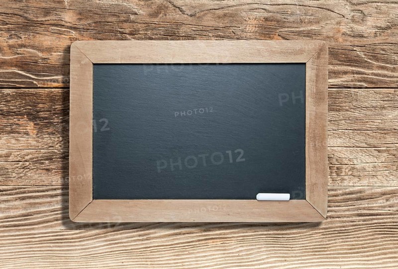 Blank slate black chalkboard with chalk on aged wood background