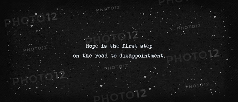 Hope is the first step on the road to disappointment. Famous quote as text art illustration. Typewriter font style over vintage paper dark background