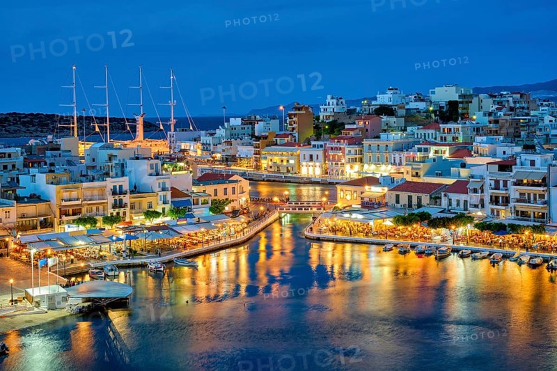 Beautiful Agios Nikolaos town on lake Voulismeni at night. Lasithi region of Crete island
