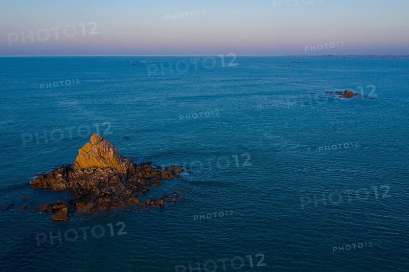 Aerial view of rock formations in the sea in front of the sandy beach Ker Emma shortly in front of sunset
