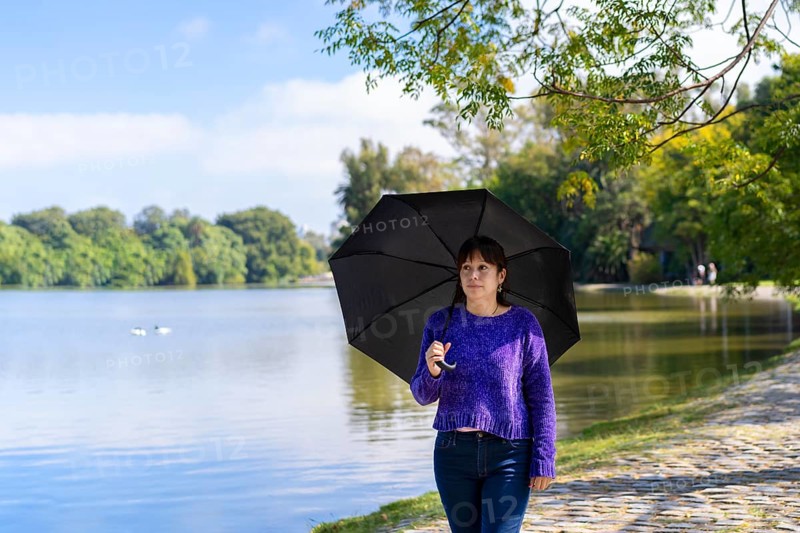 Latin woman with umbrella on a sunny day