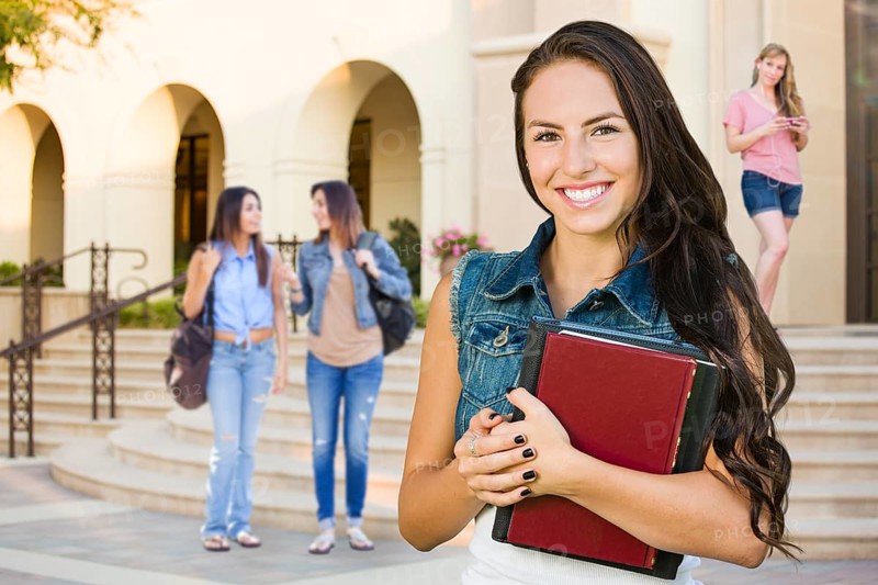 mixed-race young girl student with school books on campus