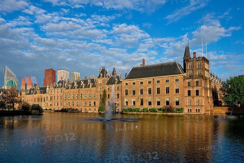 View of the Binnenhof House of Parliament and the Hofvijver lake with downtown skyscrapers in background. The Hague