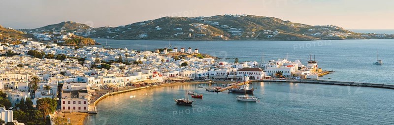 View of Mykonos town Greek tourist holiday vacation destination with famous windmills