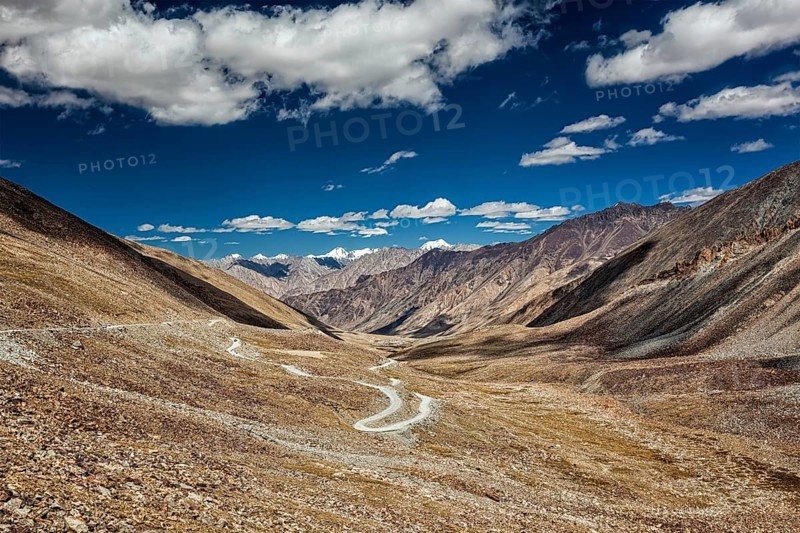 View of Karakoram range and road in valley from Kardung La