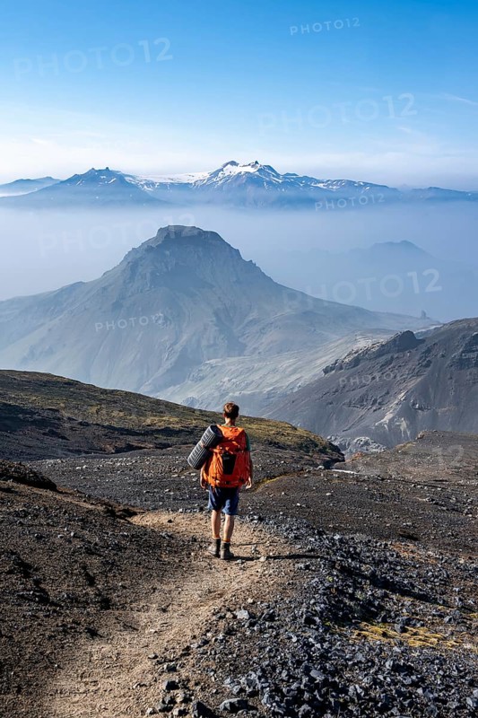 Hikers on hiking trail through volcanic landscape