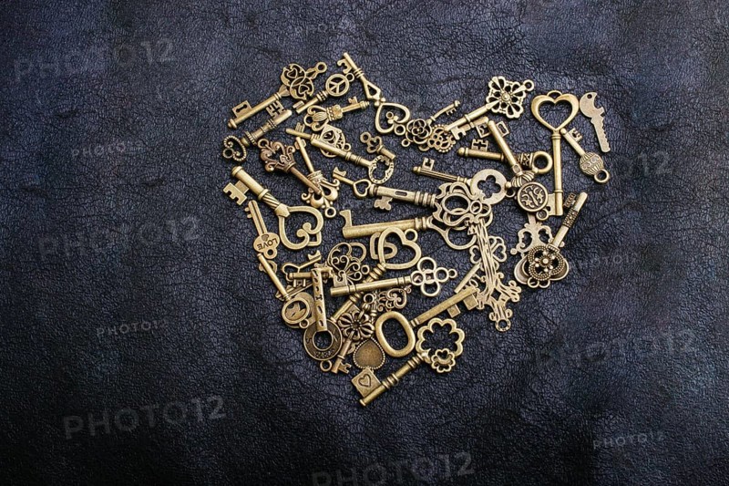 Retro metal keys form a heart shape on black