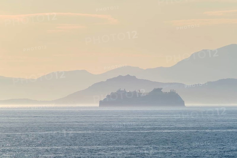 Cruise liner ship silhouette in haze in Mediterranea sea