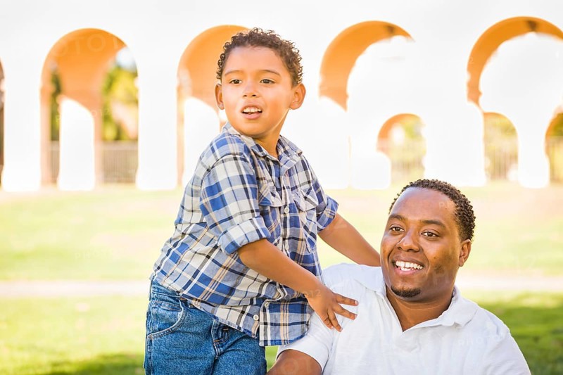 Happy african american father and mixed-race son playing at the park