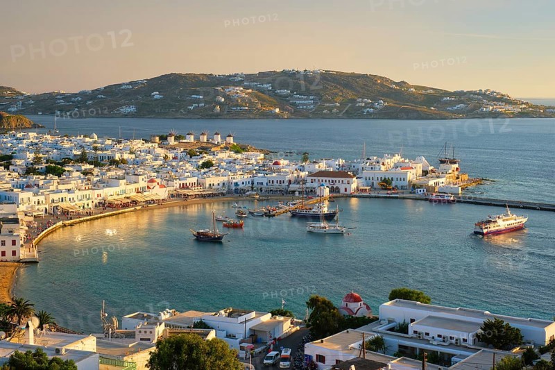 View of Mykonos town Greek tourist holiday vacation destination with famous windmills