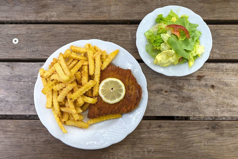 Cordon bleu with french fries and salad plate served in an inn