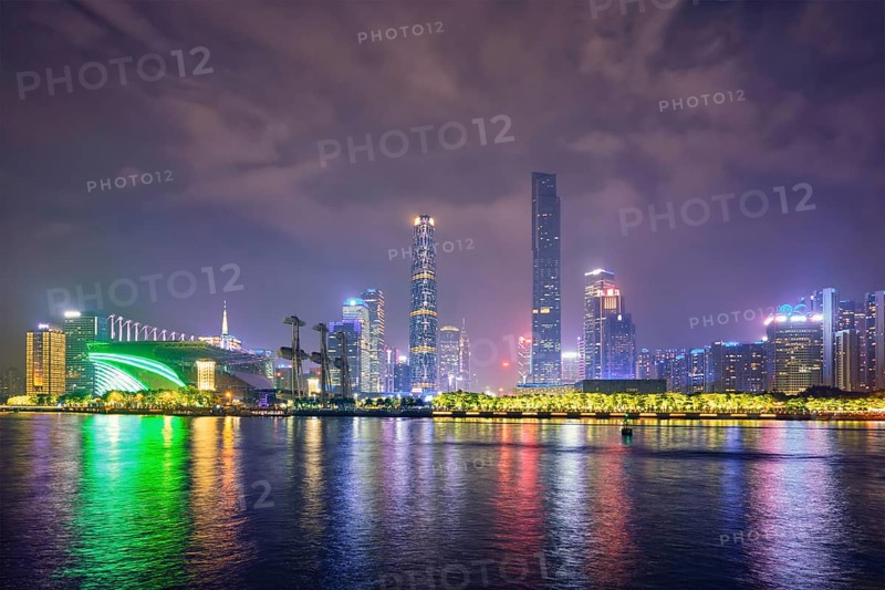 Guangzhou cityscape skyline over the Pearl River illuminated in the evening. Guangzhou