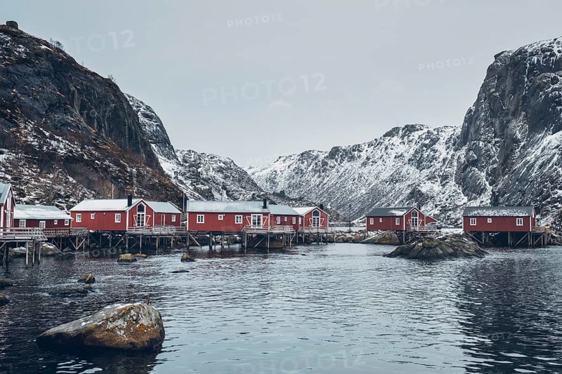 Nusfjord authentic traditional fishing village with traditional red rorbu houses in winter in Norwegian fjord. Lofoten islands
