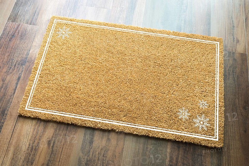 Blank holiday welcome mat with snow flakes on wood floor background