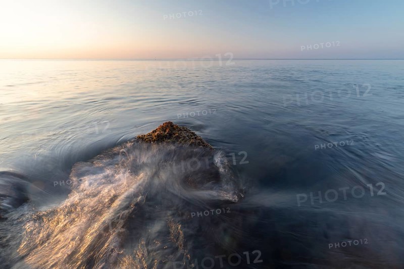 Waves lap a rock