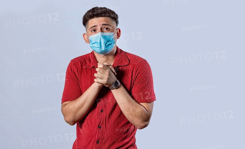 Latin man begging with medical protective face mask. pleading man concept isolated