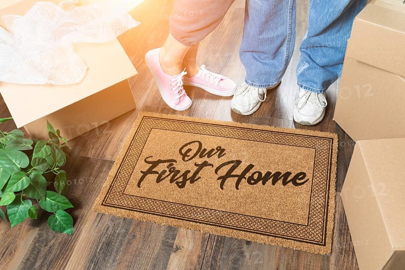 Man and woman unpacking near our first home welcome mat