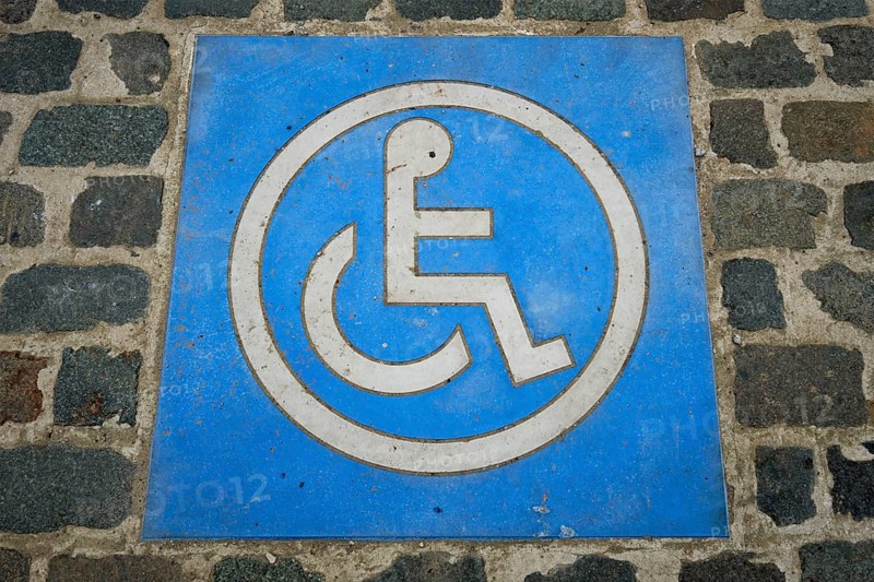 Disabled handicapped Parking Sign on cobblestone parking lot