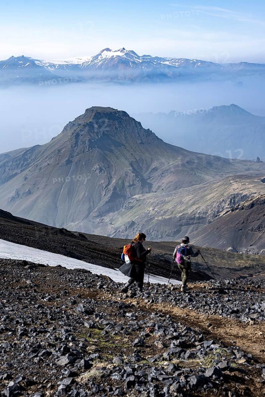 Two hikers on hiking trail through volcanic landscape