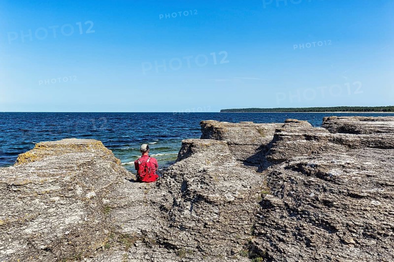 Hiker sitting between limestone columns