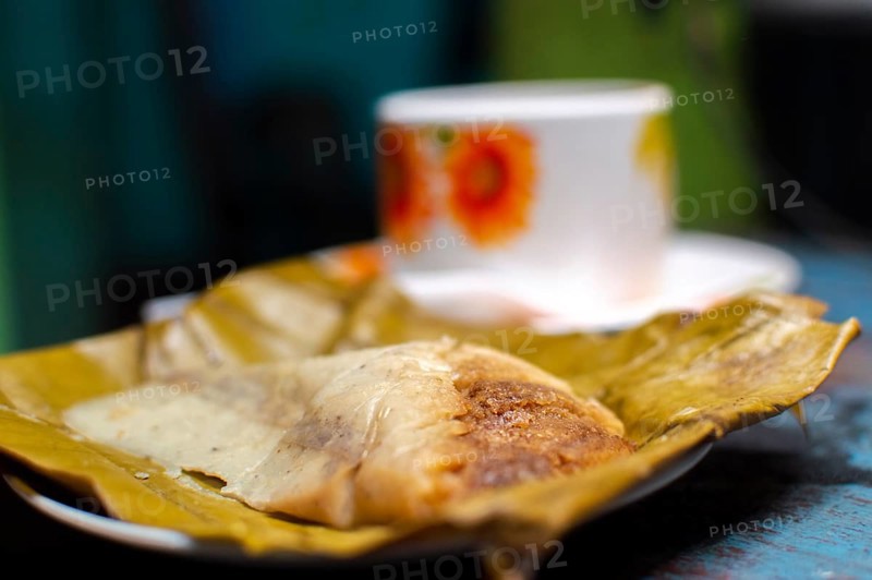 Stuffed tamale served on wooden table