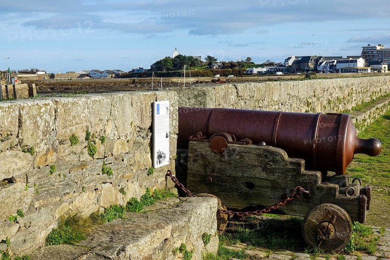 Old cannon on the quay wall of the port of Roscoff