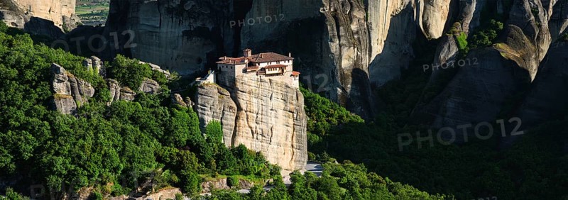 Panorama of Monastery of Rousanou in famous greek tourist destination Meteora in Greece on sunset with scenic landscape