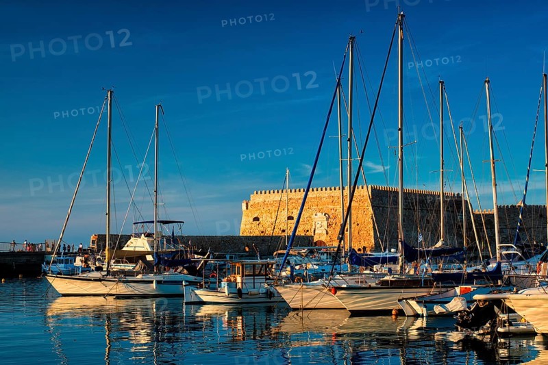 Venetian Fort Venetian fortress of Koules Castello a Mare castle in Heraklion and moored Greek fishing boats in port