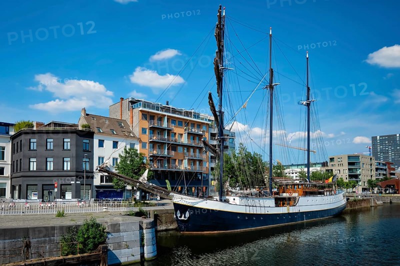 Ship moored in Willemdock in Antwerp. View of Bonapartedok harbor and vintage galleon. Antwerpen