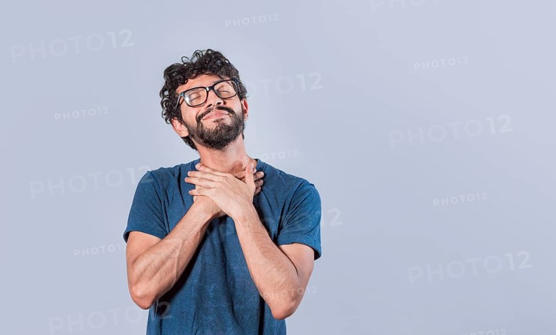 Attractive friendly and positive looking young man with a charming sincere smile feeling grateful