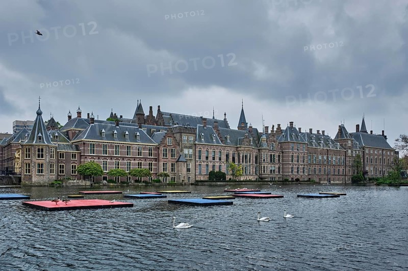 View of the Binnenhof House of Parliament and the Hofvijver lake with swans