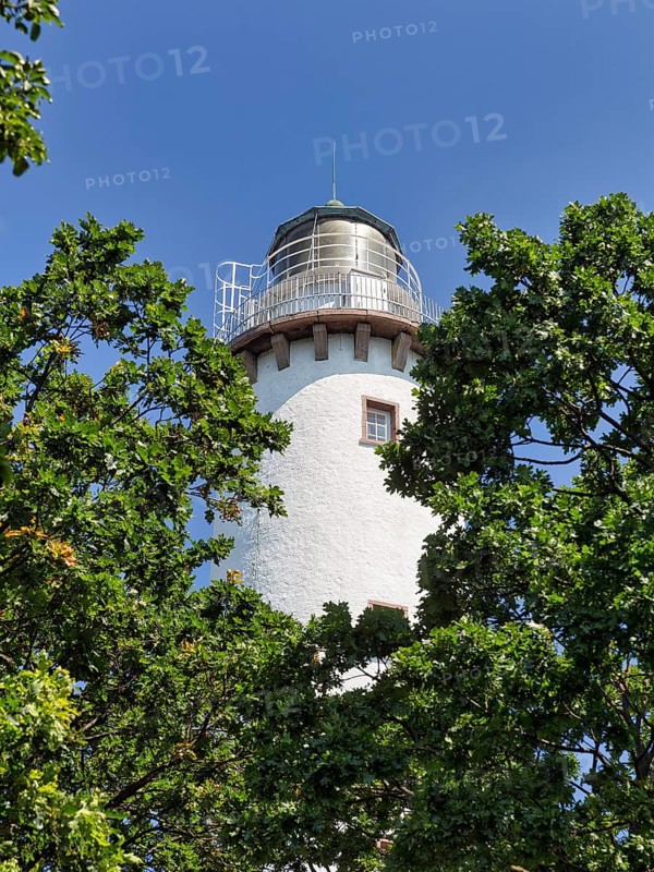 White lighthouse Langer Erik between trees
