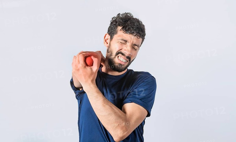 Man with elbow cramp