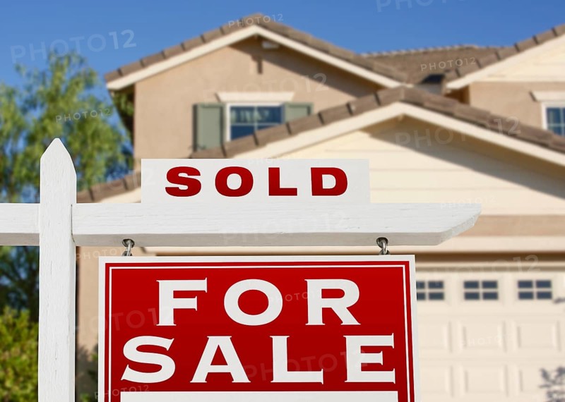 Sold home for sale real estate sign and house