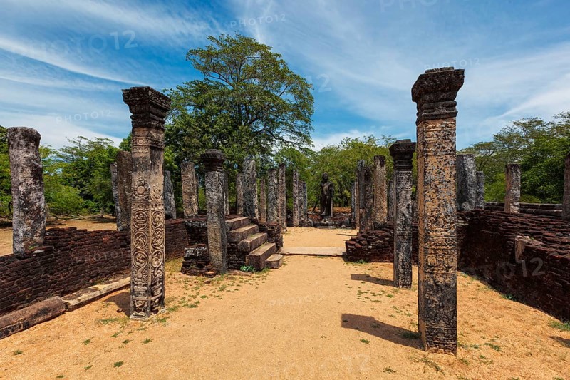 Standing Buddha statue in ancient ruins