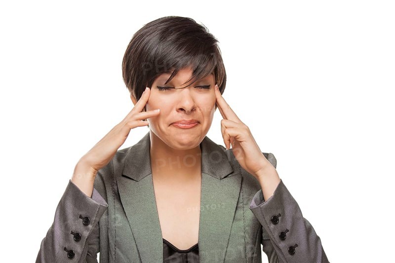 Grimacing biracial girl holding her head with her hands isolated against white background